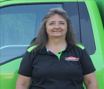 Photo of Christie in front of decaled SERVPRO Service Van