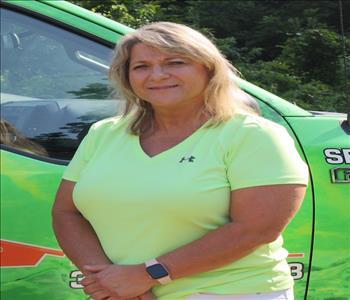 Photo of Pam in front of decaled SERVPRO Service Van