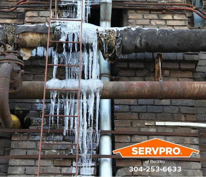 Frozen water pipes can be seen outside a commercial property.