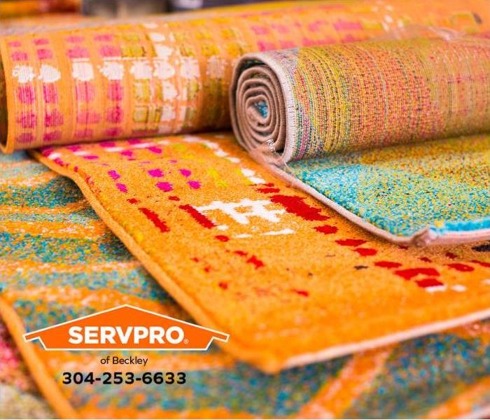Clean, colorful throw rugs are shown partially unrolled.