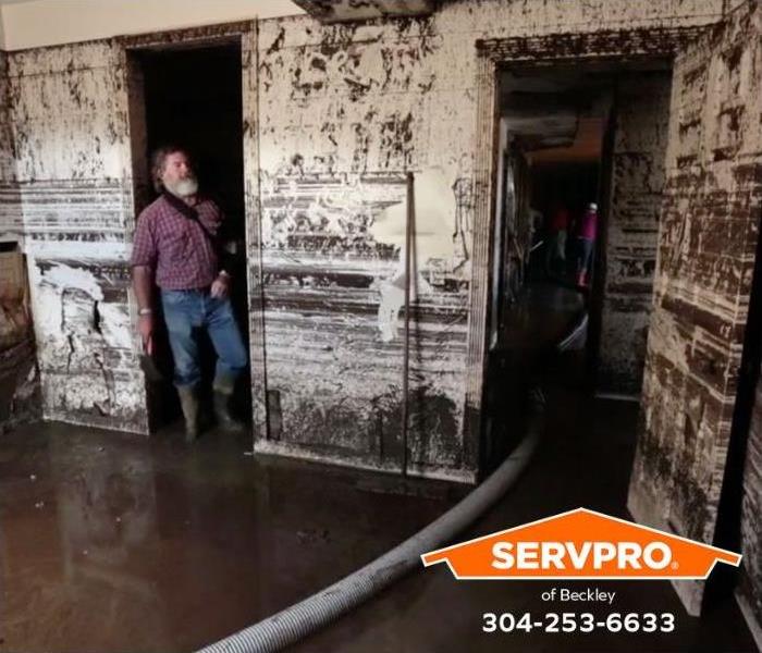 A flooded building shows signs of mold damage.
