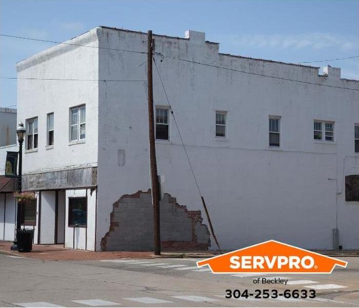 A two-story commercial building shows damage